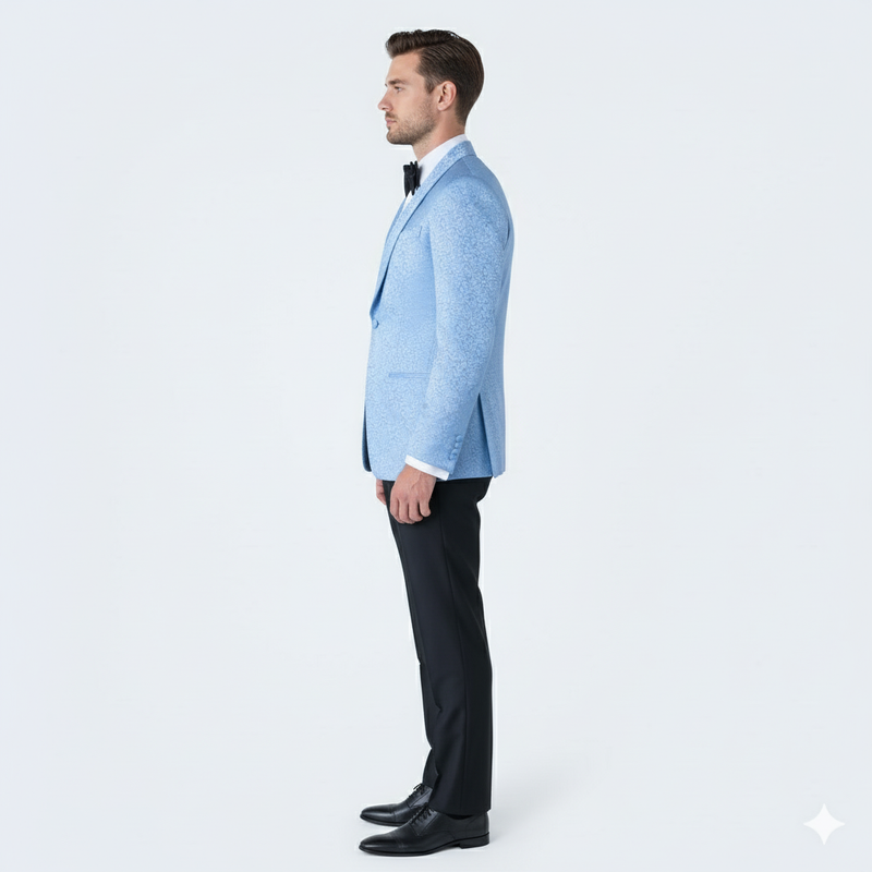 Light blue Alberto Nardoni men's tuxedo jacket. Paisley pattern, structured silhouette, single-button closure, shawl lapels. Lightweight fabric with subtle texture. Paired with black pants and white shirt.

