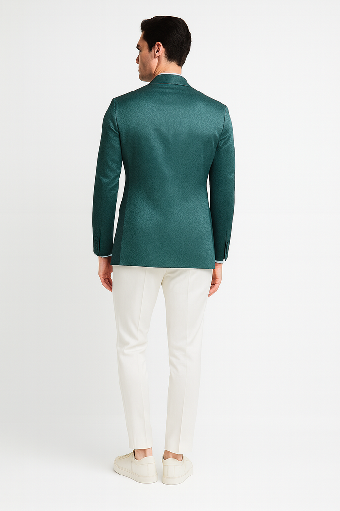 Men's teal green floral jacquard blazer. Slim fit, structured shape with tonal floral pattern. Notched lapels, long sleeves, waist length. Smooth fabric with slight sheen.
