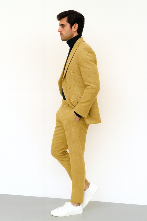 Alberto Nardoni men's gold double-breasted suit. Tailored, structured silhouette with a textured, subtle patterned fabric. Features double-breasted jacket with peak lapels and slim-fit trousers.
