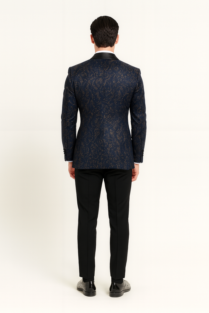 Navy sequin tuxedo jacket for men. Black satin shawl lapel. Textured sequins enhance navy color. Tailored fit with defined shoulders, single-breasted, long sleeves, button cuffs.
