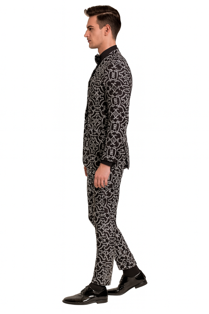 Men's black sequin tuxedo with silver accents. Fitted blazer and slim trousers. Intricate, shimmering pattern. Elegant, structured design.
