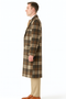 Vintage men's plaid overcoat. Long, tailored wool coat with a smooth silhouette. Dark green, cream, and orange plaid pattern. Notched collar, single-button closure, and side pockets.
