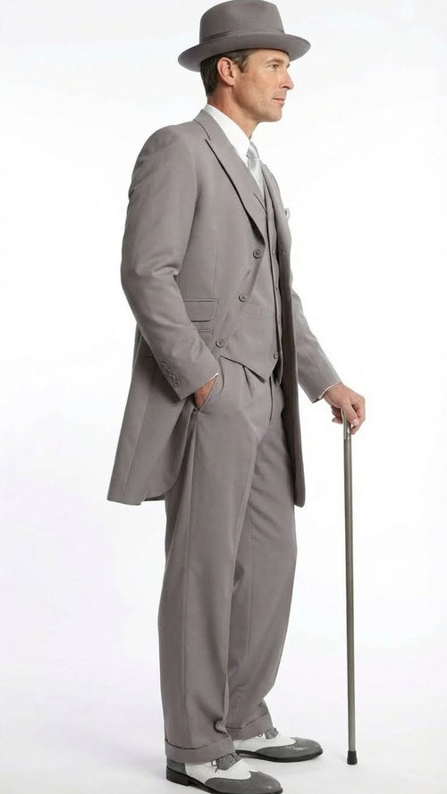 Men's gray zoot suit: long jacket, wide trousers, double-breasted design, prominent lapels. Includes matching hat & gray/white wingtip shoes, 1920s style.