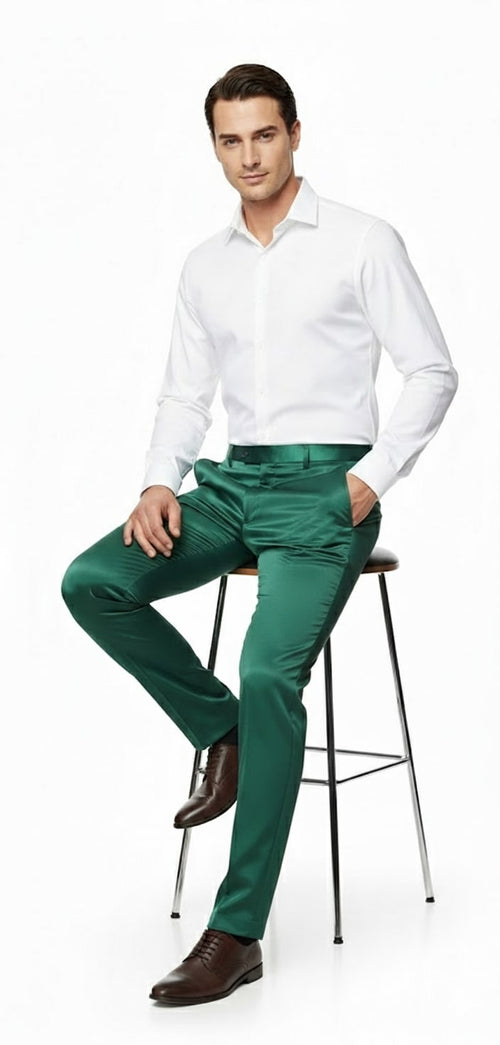 Emerald green satin slim-fit dress pants. Shiny, smooth fabric with a tailored cut. Fitted waist, straight legs, and a glossy finish for a sleek silhouette.
