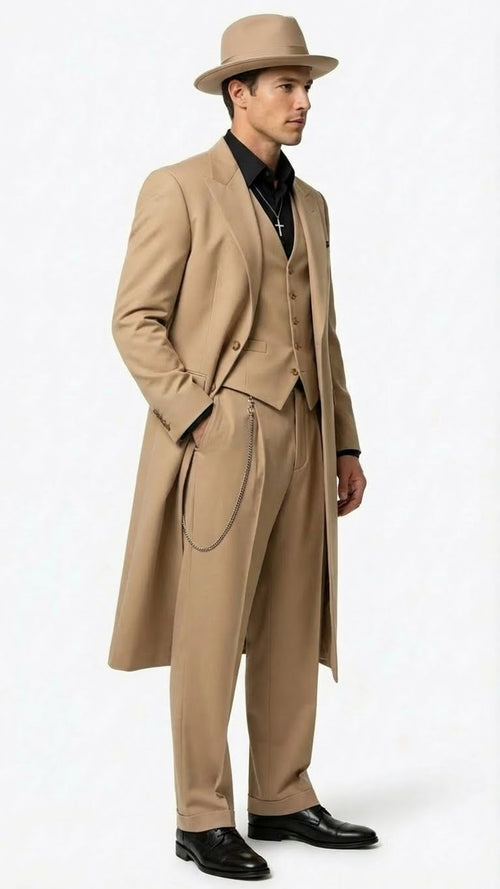 Alberto Nardoni men's 1920s-style zoot suit: beige, long tailored jacket, fitted waist, wide lapels, high-waisted pleated pants, matching hat. Smooth fabric, structured silhouette, chain detail.