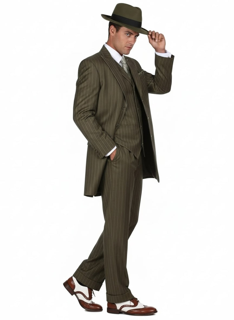Men's olive green pinstripe zoot suit: three-piece (jacket, waistcoat, trousers). Features long jacket, wide-legged trousers, and pinstripes. Vintage style. Paired with brown & white shoes.
