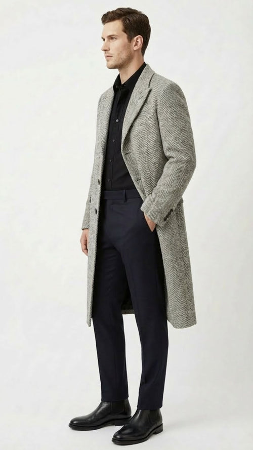 Alberto Nardoni men's grey herringbone overcoat. Mid-length, tailored silhouette with wide lapels and double-breasted closure. Features a classic herringbone pattern, two front pockets, and textured wool blend fabric.
