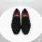Men's black slip-on loafers with a rounded toe. Covered in black spikes for a textured look. Red lining. Stylish and edgy design.
