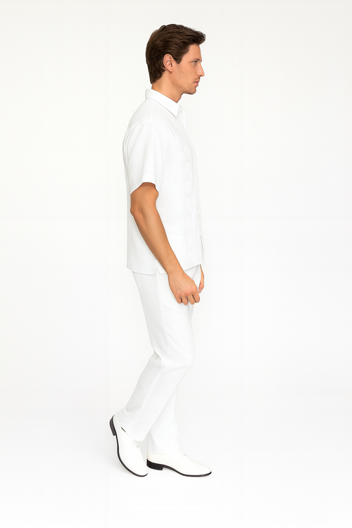Men's white linen guayabera set: short-sleeve embroidered shirt & matching pants. Classic collar, relaxed fit shirt. Tailored pants for a streamlined look. Both pieces are solid white.
