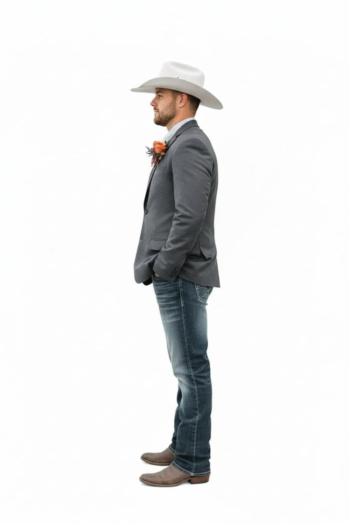 Classic gray western blazer with tailored fit, notch lapels, and textured fabric. Paired with blue jeans for a contrasting style. Worn over a light shirt.
