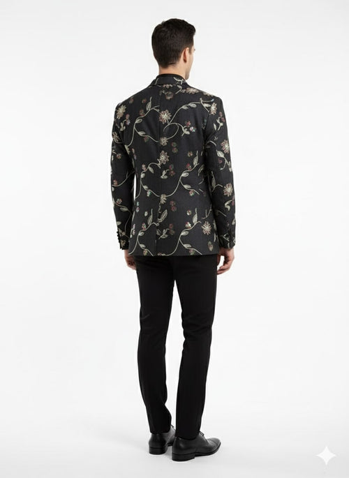 Black floral embroidered blazer: fitted silhouette, elegant back, colorful floral embroidery on black. Smooth fabric, notched lapels, single back vent. Luxurious and upscale.
