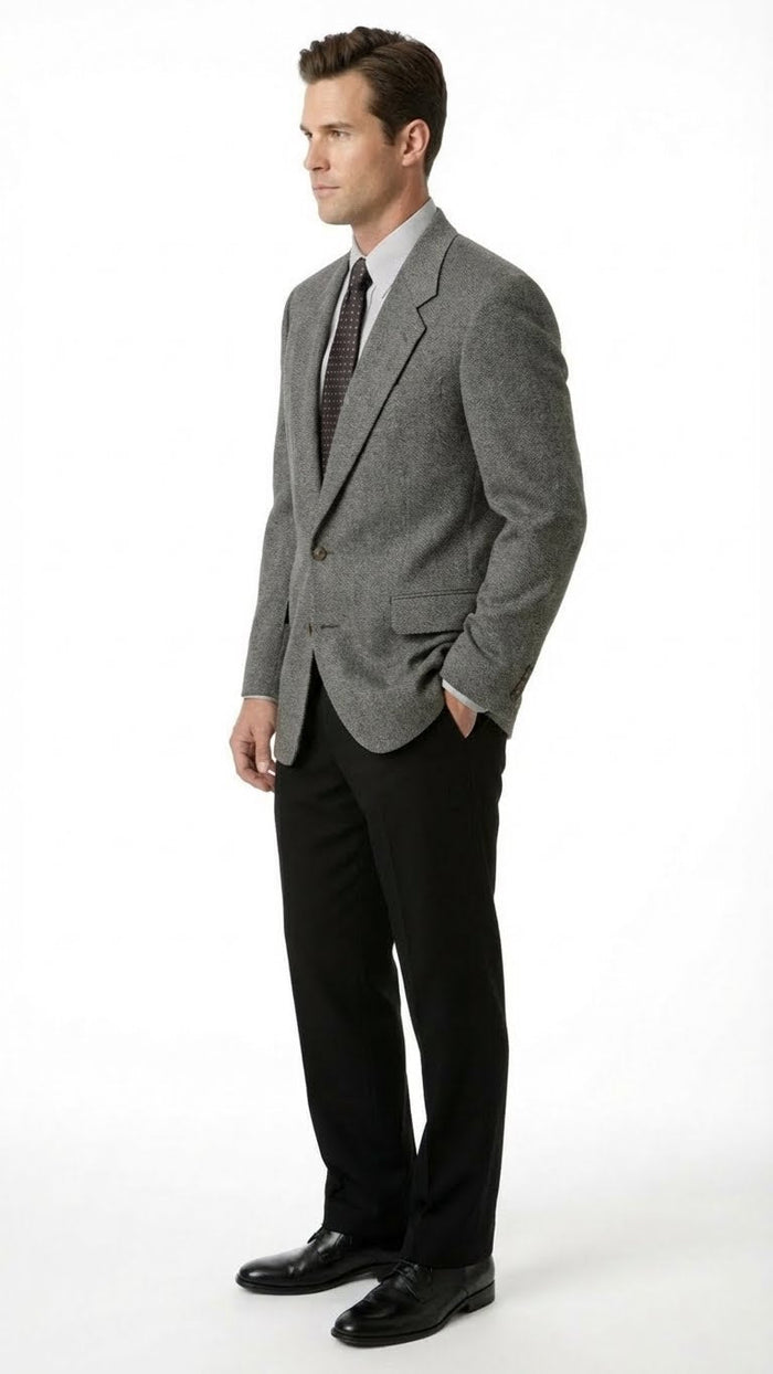 Alberto Nardoni men's dark grey blazer with charcoal sport coat, structured shape, single-button closure, notched lapels, and textured fabric. Paired with black trousers.
