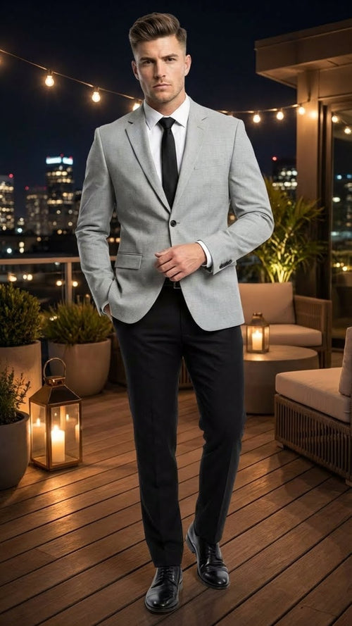 Light grey slim-fit blazer with notched lapel. Paired with black slim-fit pants. Single-breasted design, two front pockets, smooth texture. A classic, refined look.
