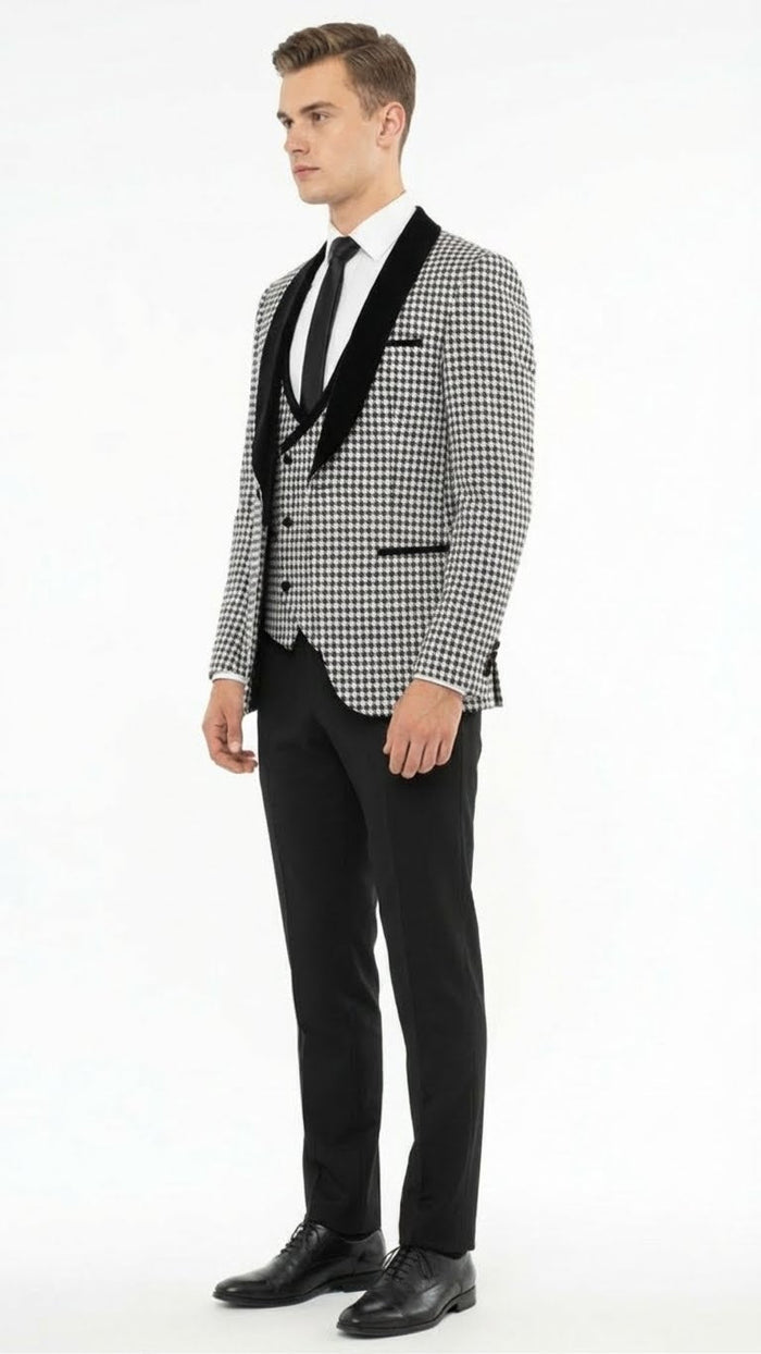 Men's houndstooth tuxedo set: black & white. Structured jacket with velvet shawl lapel & peaked collar. Fitted black trousers complete the formal look.
