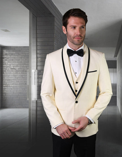 Ivory wool tuxedo with shawl lapel, black satin trim, and a structured fit. Features a single-button closure, three pockets, and back vent. Matching five-button vest with classic collar.
