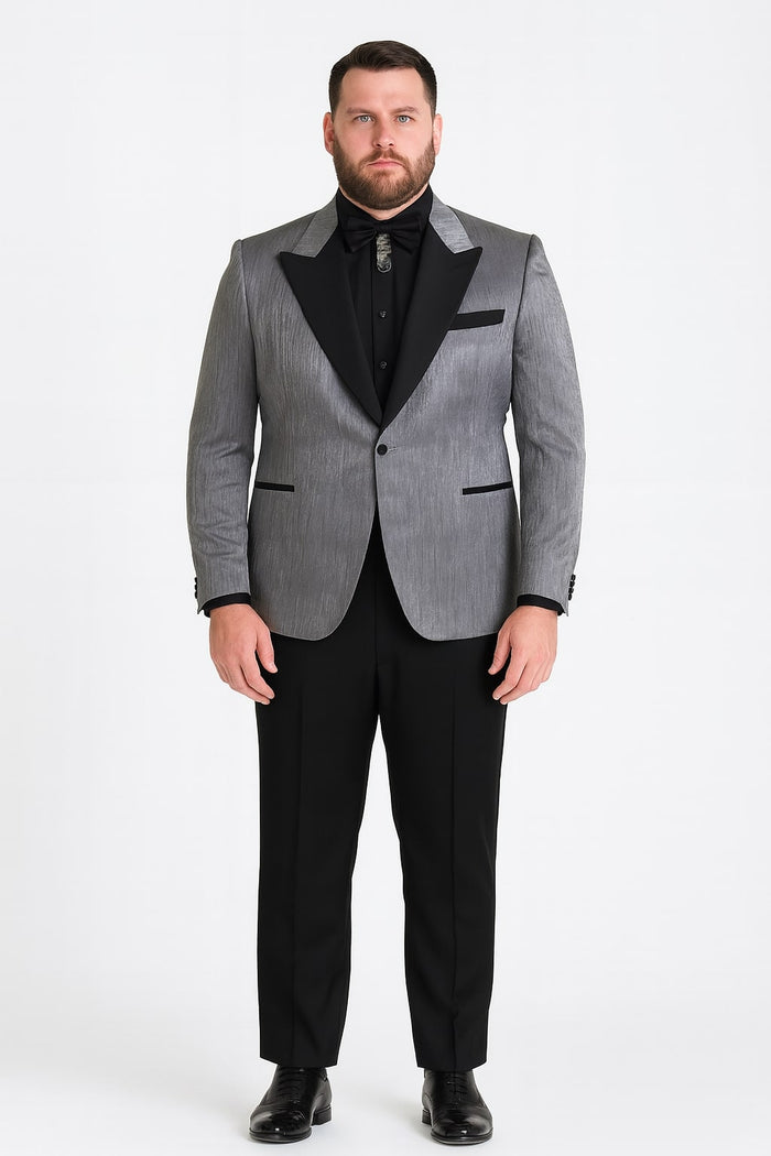 Silver metallic tuxedo suit with black satin peak lapel and textured jacket. Solid black tailored trousers. Includes black shirt and bow tie for a formal look.
