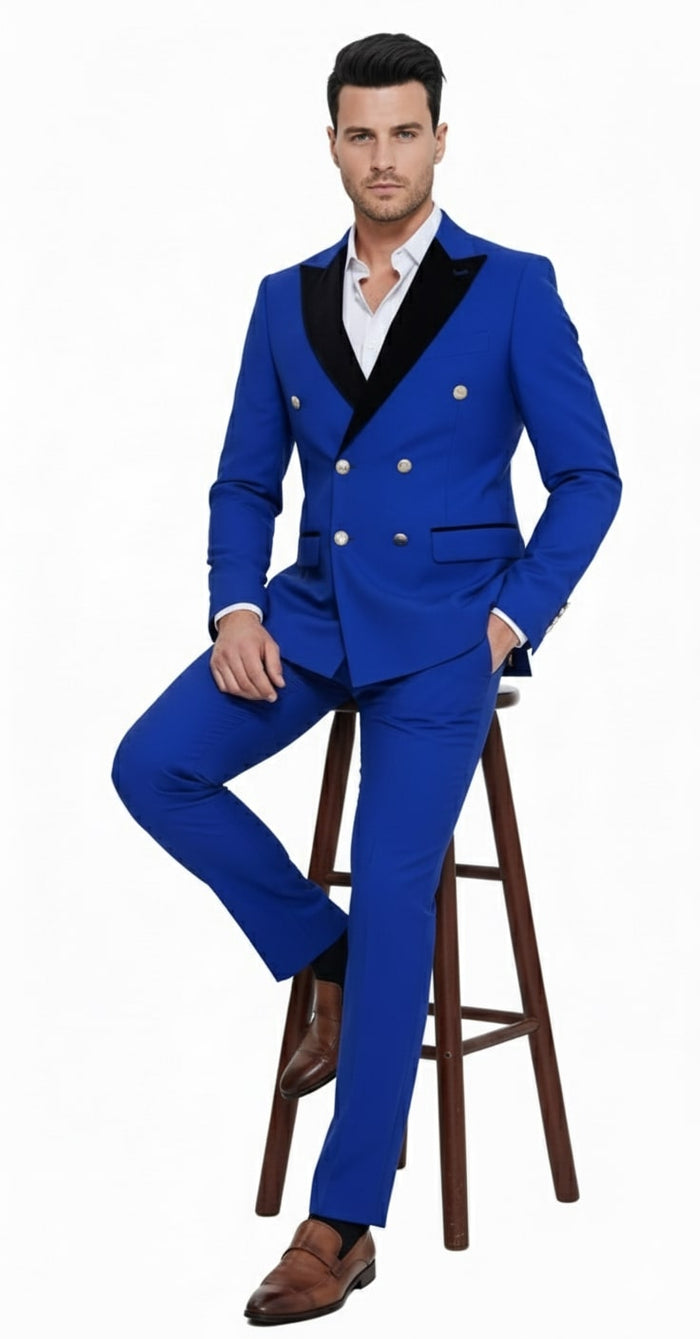 Royal blue men's double-breasted tuxedo suit. Modern slim fit, black satin lapel, gold buttons. Matching royal blue, straight-leg trousers. Two side pockets.
