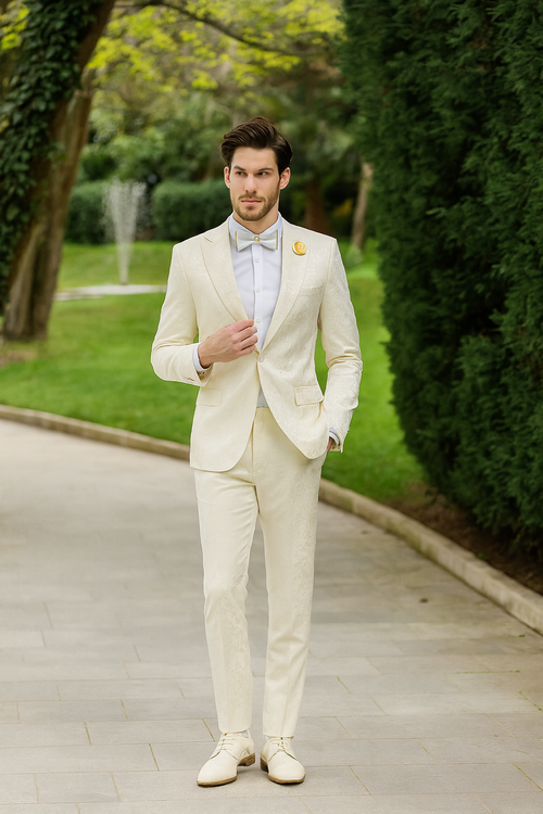 Men's ivory jacquard tuxedo suit with paisley pattern. Includes a jacket with satin shawl lapel, matching trousers, a white shirt, and a coordinating bow tie.
