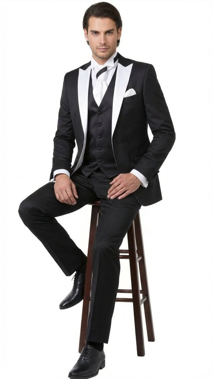 Classic men's black and white prom tuxedo: black jacket with white lapels, black vest, matching trousers. Includes white bow tie and pocket square. Tailored fit, smooth fabric.
