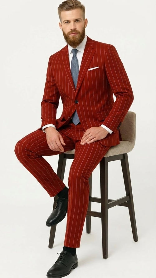 Men's red pinstripe suit with a two-button jacket and vest. Crafted from smooth fabric, it offers a structured fit. Vertical white pinstripes add visual interest to the design.
