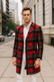 Red plaid wool overcoat for men. Classic tartan check in red, black, and white. Long coat, two pockets, single-button closure, and textured wool fabric.
