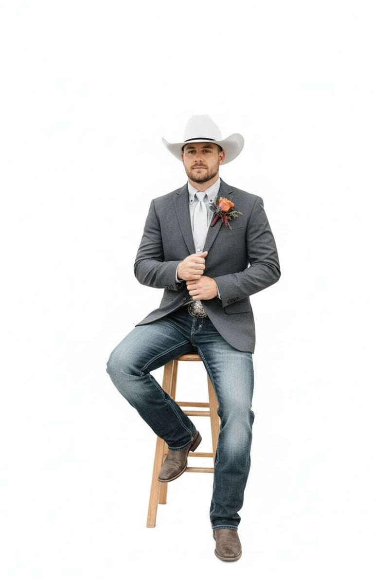 Classic gray cowboy suit jacket with single-breasted design, structured shoulders, and notched lapels. Features two front pockets and a boutonnière. Made of sturdy gray fabric. Worn over a light dress shirt.
