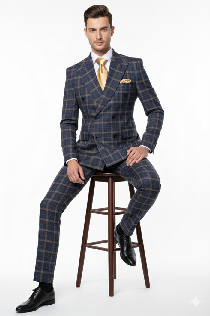 Men's double-breasted suit in camel bronze/khaki plaid. Smooth fabric, structured blazer with wide lapels & 2 rows of buttons. Straight-leg trousers. Paired with a light shirt & contrasting tie.