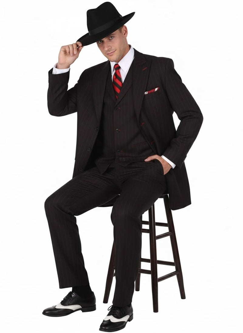 Men's black & red pinstripe zoot suit: long jacket, vest, trousers. Includes white shirt, striped tie, pocket square, loose-fit trousers, wide lapels, & black shoes with white accents.
