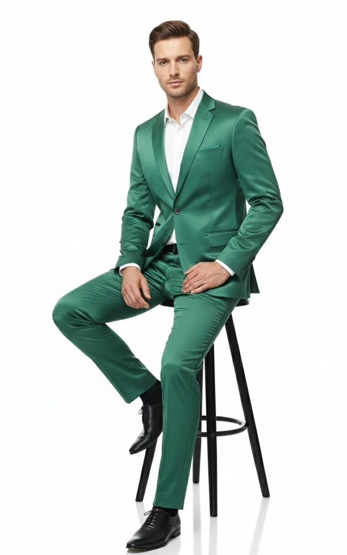 Emerald green sateen two-piece slim fit suit. Features single-button blazer with notched lapels & chest pocket, plus straight-leg pants. Smooth, reflective satin fabric.
