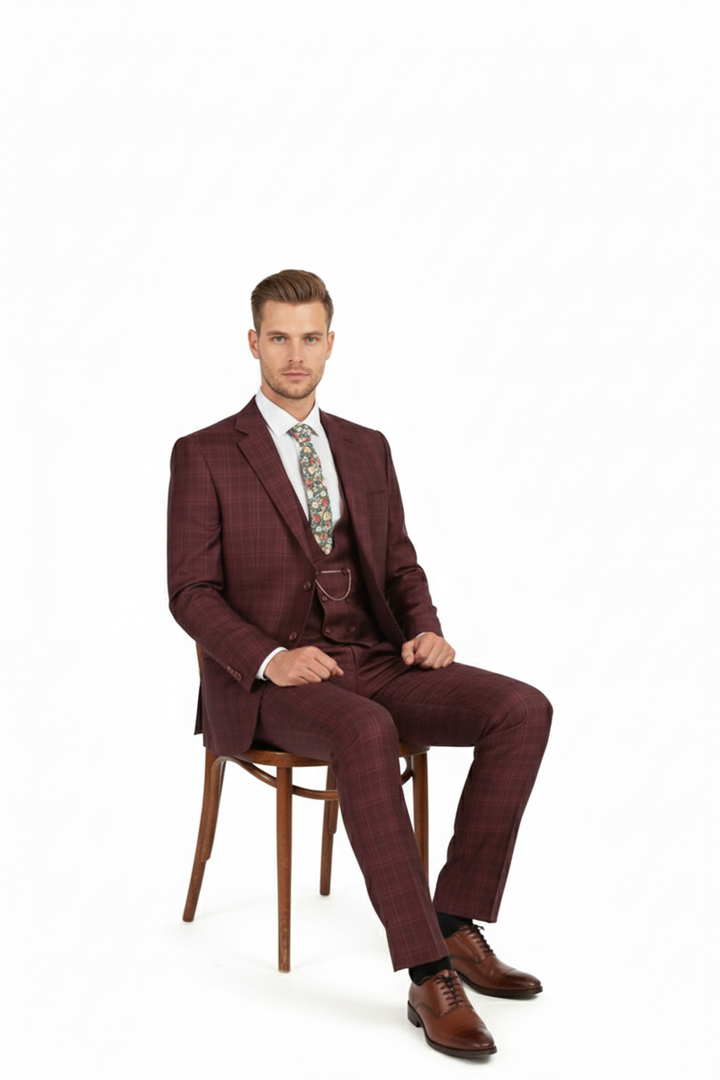 Burgundy checkered three-piece suit for men. Classic fit plaid blazer (notch lapel, single-button), vest, and straight-leg pants. Features a windowpane pattern. Includes a separate floral tie.
