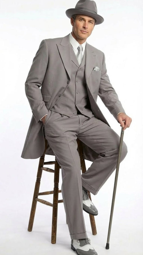 Men's gray zoot suit with matching hat. Features a long jacket, wide-legged trousers, and lightweight fabric. Includes gray & white 1920s-style wingtip shoes, offering color/texture contrast.
