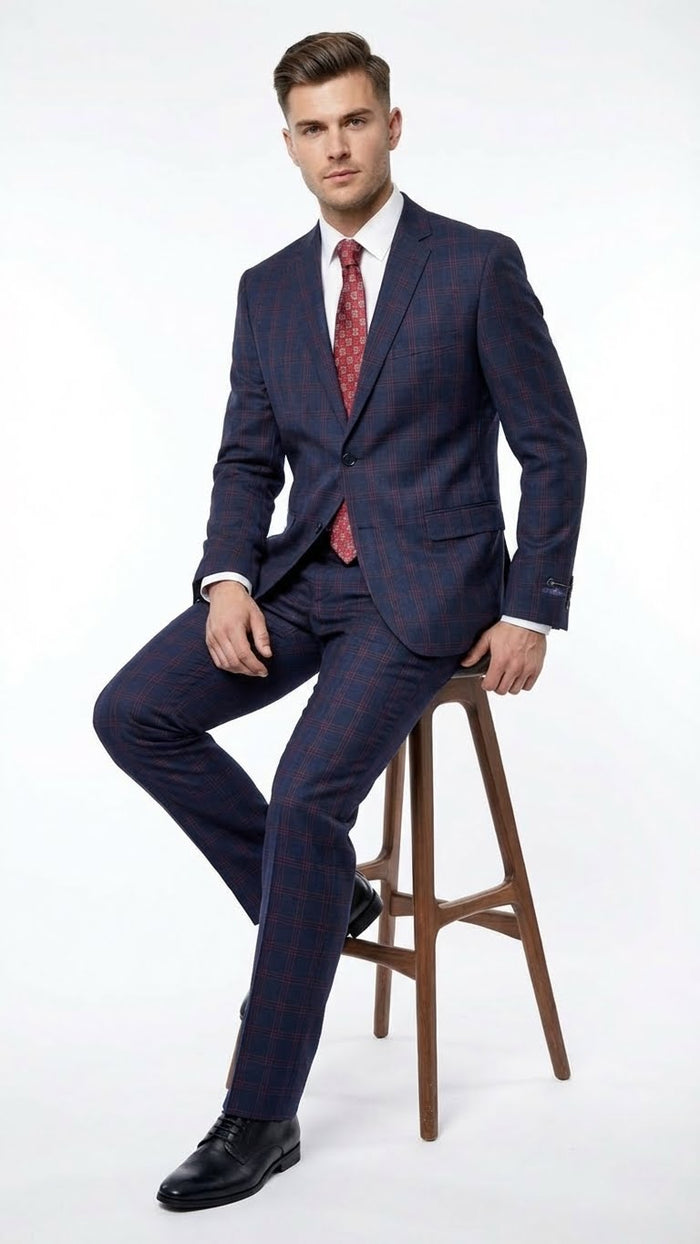Navy and burgundy checkered men's two-piece suit. Features a plaid windowpane pattern, fitted jacket with notch lapels, and flat-front trousers. Textured, likely wool blend fabric.
