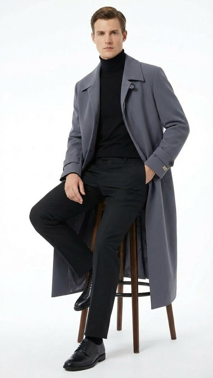Alberto Nardoni charcoal grey overcoat. Full-length, structured silhouette with classic collar and button closure. Smooth wool-like material, straight cut to below knees. Lined interior, tailored fit.
