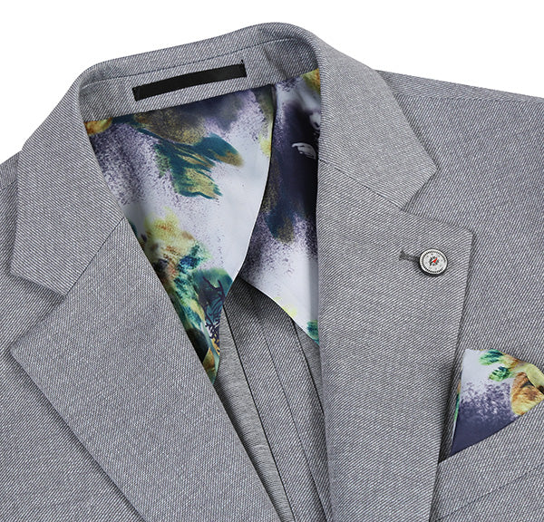 Gray, half-canvas slim fit blazer. Light gray textured fabric, notch lapel, single-button closure. Colorful abstract lining visible at collar. Decorative pocket square.
