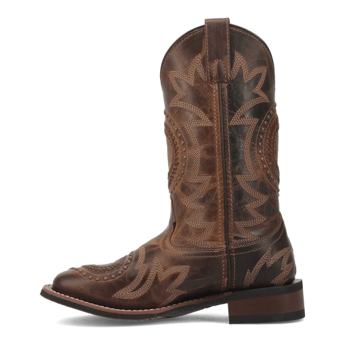Laredo Charli women's boot: tall, distressed brown leather with pointed toe and stacked heel. Geometric stitching detail. Features pull tab. Sturdy sole for durability.
