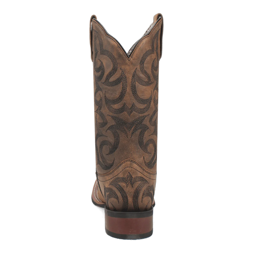 Laredo Sariah boot. Tall brown leather shaft with pointed top and decorative stitching. Intricate swirling patterns for contrast. Stacked heel, rounded toe.
