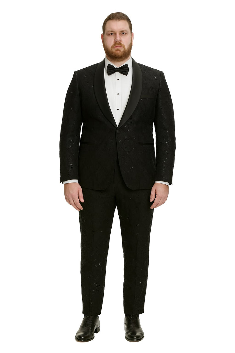 Black sequin tuxedo suit with satin shawl lapel. Fitted design, textured sequins. Tailored trousers match the blazer. White shirt and black bow tie complete the look.
