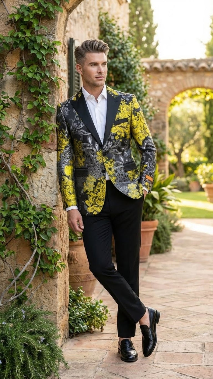 Yellow men's tuxedo blazer with black & gold floral pattern. Fitted silhouette, shawl lapel, single-button closure, and two front pockets. Primarily yellow with intricate floral designs.
