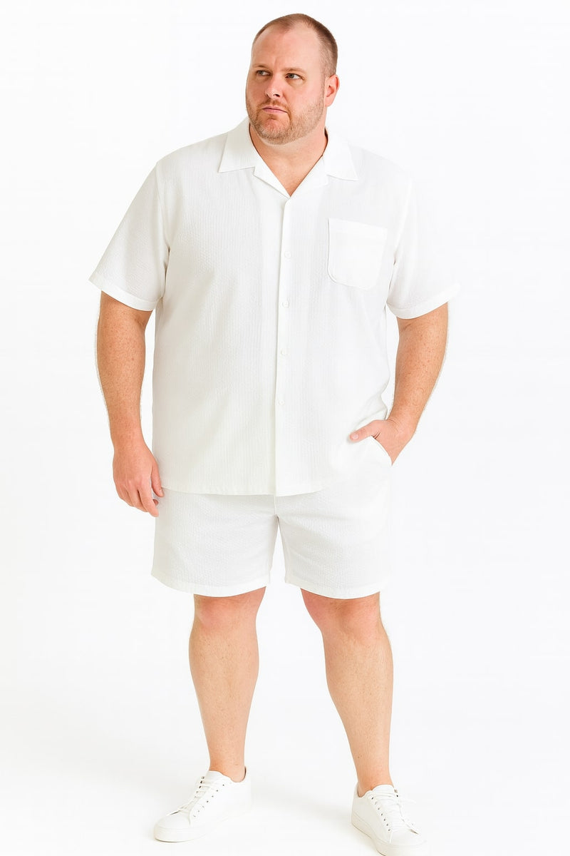 Men's short set: White seersucker shirt & shorts. Shirt: collared, short sleeves, pocket. Shorts: relaxed fit, elastic waist, hemmed cuffs. Lightweight, textured fabric.
