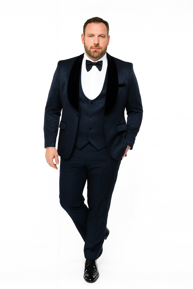 Navy jacquard tuxedo with black velvet shawl lapel and fitted silhouette. Features a three-button front and matching trousers. Classic and elegant formal wear.
