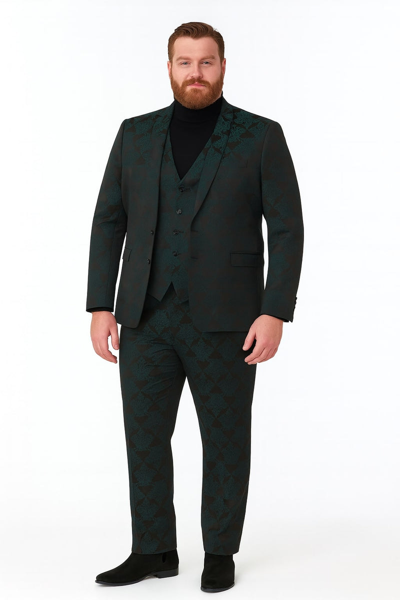 Emerald green floral jacquard 3-piece tuxedo suit for men. Features tailored jacket (single-breasted, notch lapels), waistcoat & tapered trousers. Dark floral patterns on emerald green. Worn with black turtleneck.