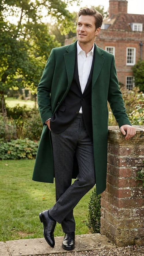 Men's hunter green wool overcoat. Tailored with a straight silhouette, single-breasted front, and notched lapels. Dense wool fabric, structured shoulders, and streamlined fit. Mid-calf length with integrated side pockets. Polished aesthetic.
