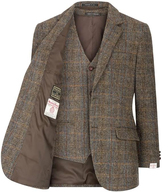 Harris Tweed Blakemore Blazer by Walker and Hawkes. Brown herringbone with blue/orange accents. Harris Tweed wool exterior, notched lapel, two pockets, single button. Brown lining, vest pattern match. Brand tag visible.
