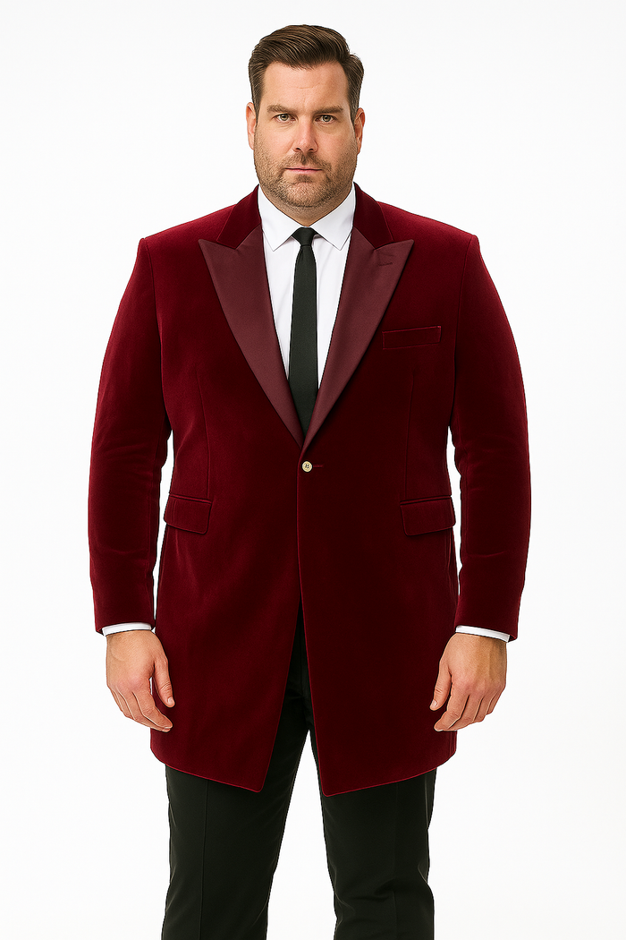 Men's burgundy velvet tuxedo with a tailored blazer. Features a shawl collar, two front pockets, and a single-button closure. The plush fabric suggests high-quality velvet.
