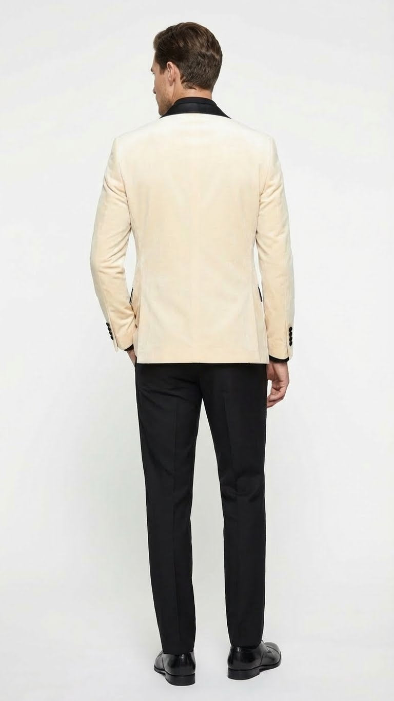 Men's ivory velvet dinner jacket with black satin lapel, tailored fit, and long sleeves. Includes black pants. Classic and elegant.
