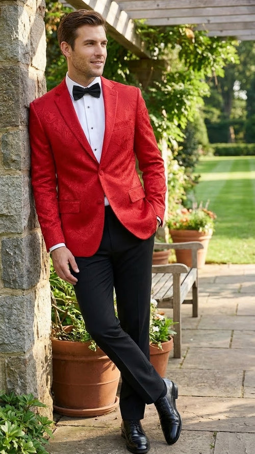 Red paisley velvet blazer, slim fit, single-button, two pockets. Features a textured pattern. Worn with a black bow tie and white dress shirt.
