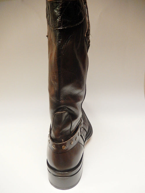 Mauri chocolate alligator knee boots 44238. Tall, sleek, rounded toe, raised heel. Dark brown glossy leather. Ankle strap with metallic studs. Subtle back stitching details.