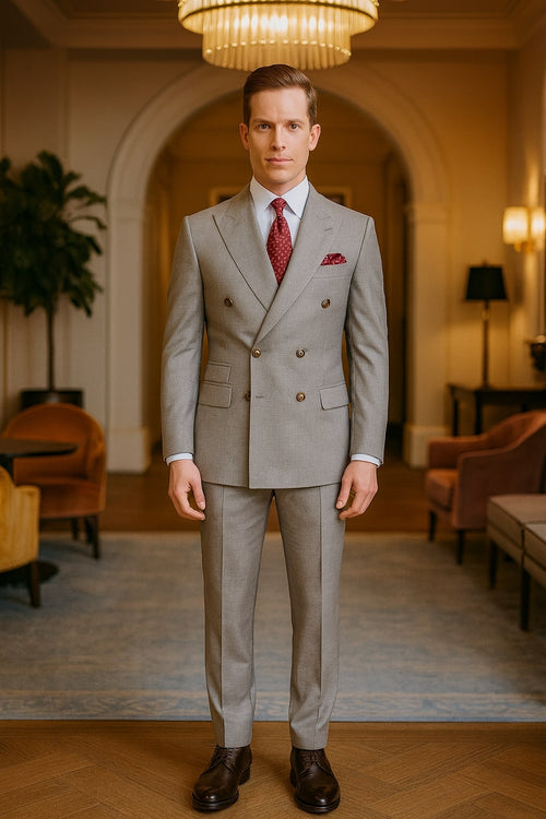 Alberto Nardoni's light grey double-breasted suit: tailored jacket with notched lapels, slim-fit pants, smooth texture. Includes a dark red tie & pocket square, finished with brown leather shoes.
