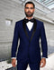 Sapphire blue men's modern fit wool tuxedo. Features a one-button closure and shawl lapel. Includes a matching vest, white shirt, and black bow tie. Tailored pants complete the ensemble.
