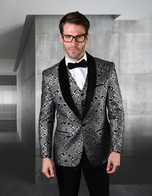 Men's black tuxedo with geometric print. One-button closure, fitted design. Features a patterned black & silver fabric, a geometric print vest, and black satin shawl collar. Includes matching black trousers.

